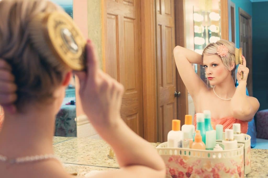 femme miroir maquille peigne