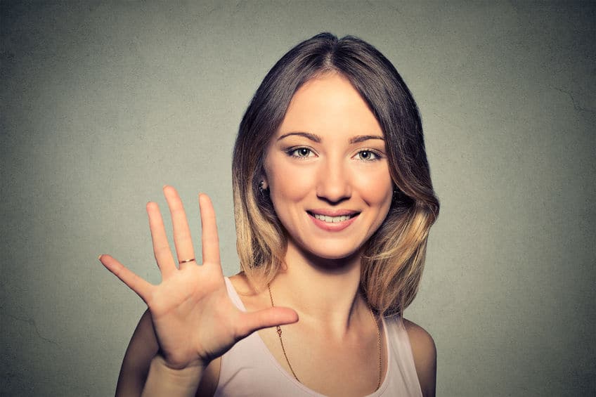 smiling woman making high five with her hand