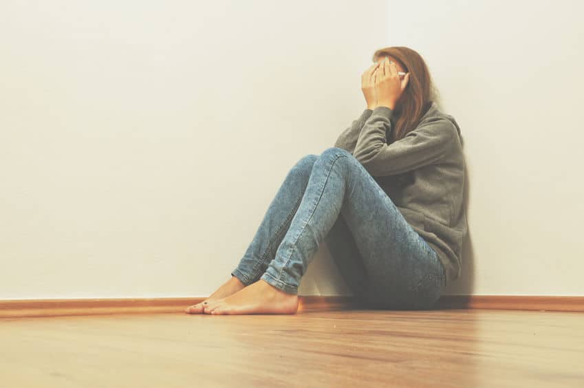 woman sad crying on floor