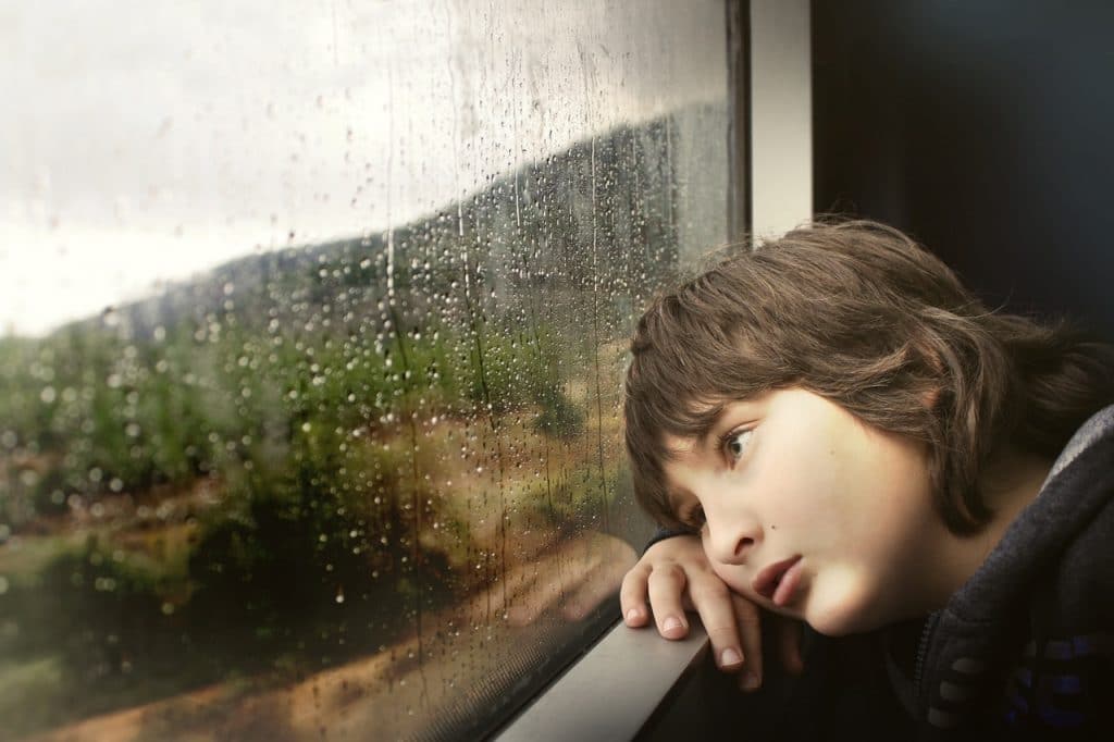 little boy window rain