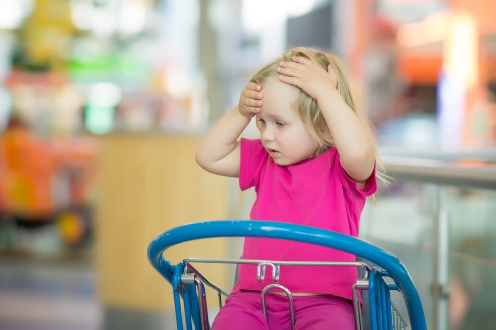 little girl in shopping cart