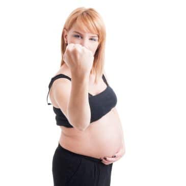 pregnant woman showing fist