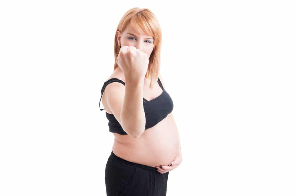 pregnant woman showing fist