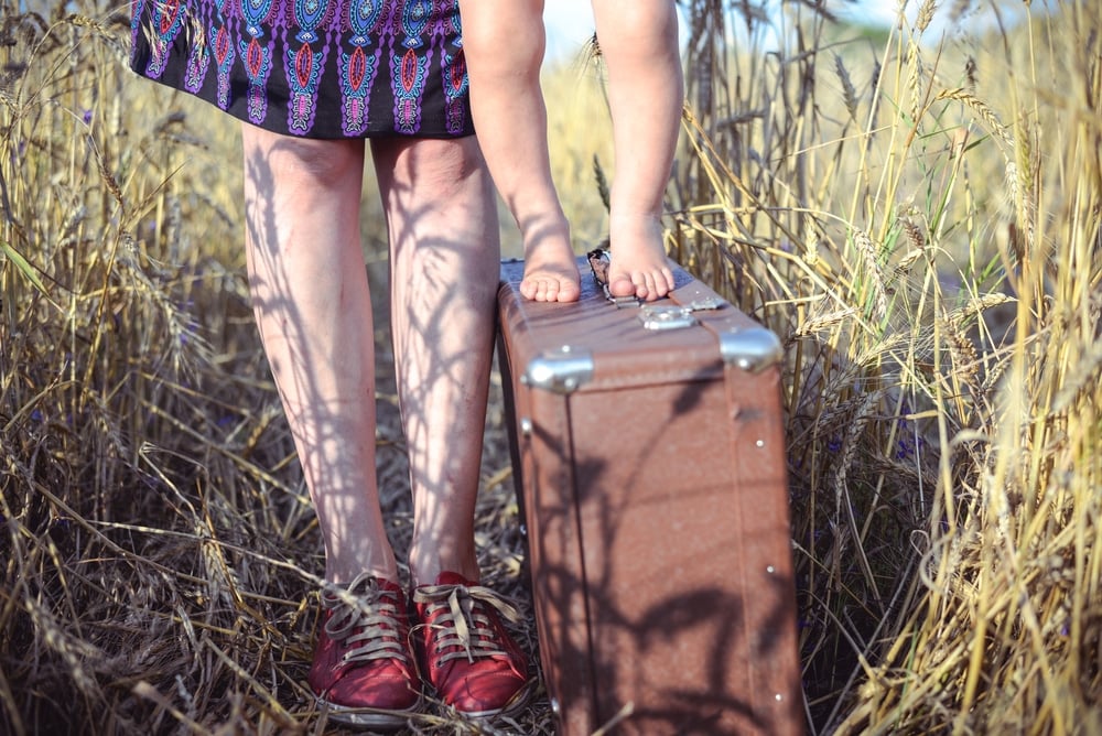 baby woman legs and suitcase