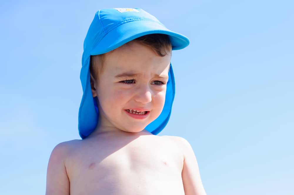 little boy crying on the beach