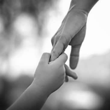 mother daughter hands black and white