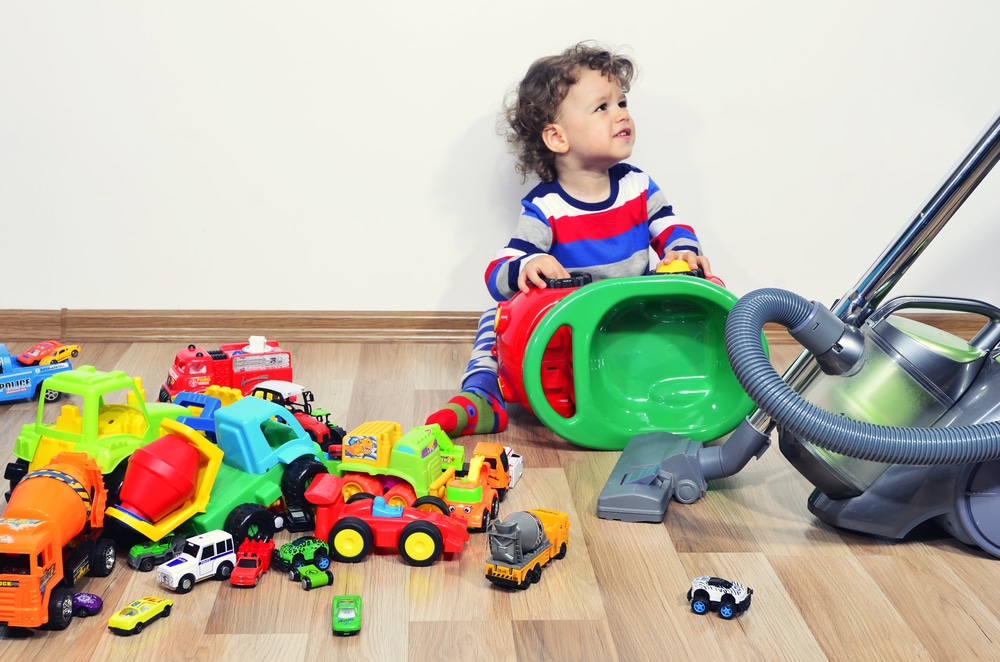 kid play with mess of toys vacuum