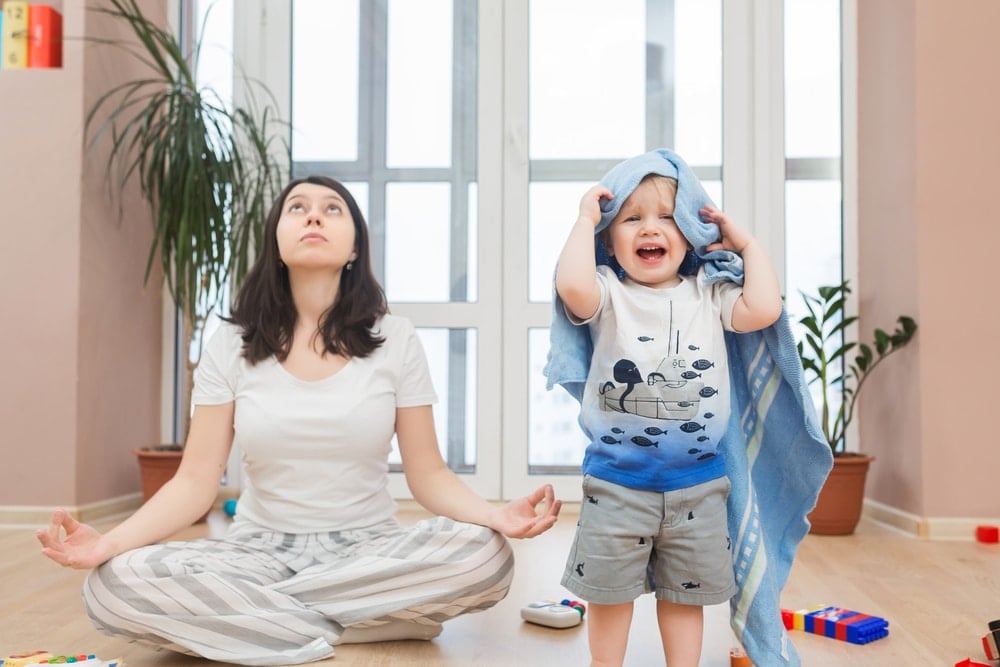 woman trying meditate with kid