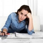 woman with calculator stressed