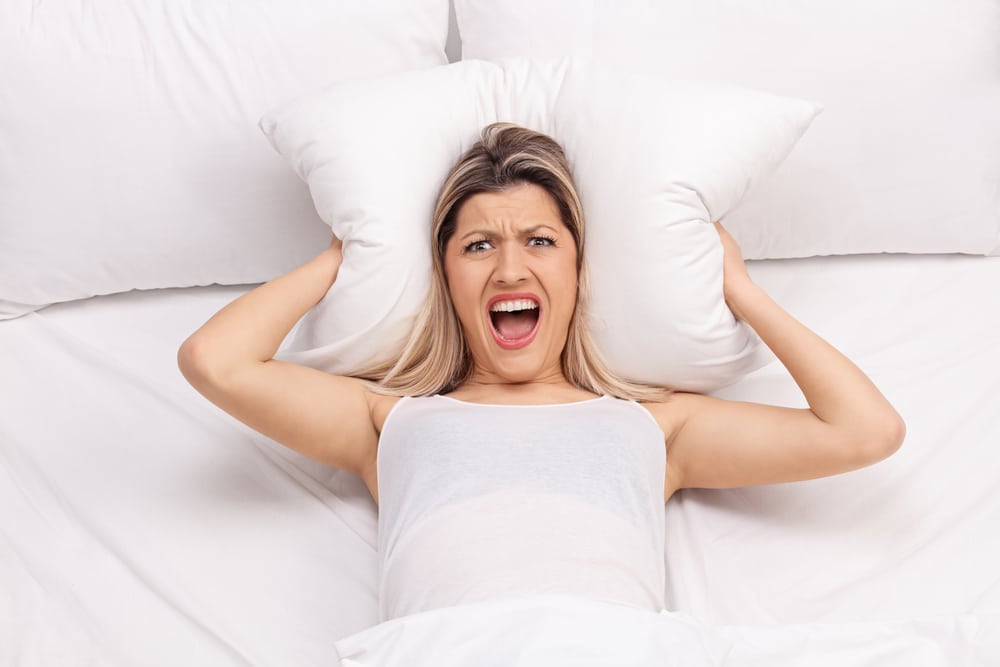 woman in bed angry