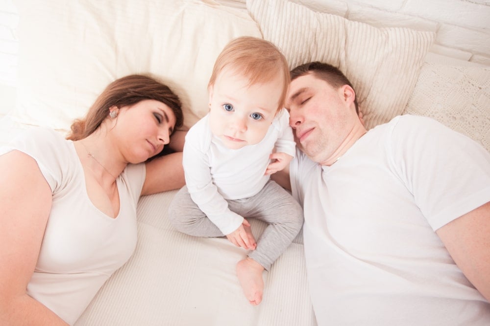 tired parents with baby