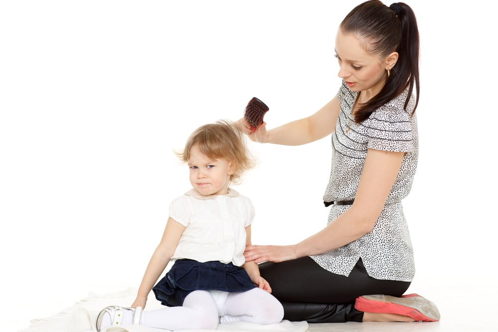 woman with daughter brush hair