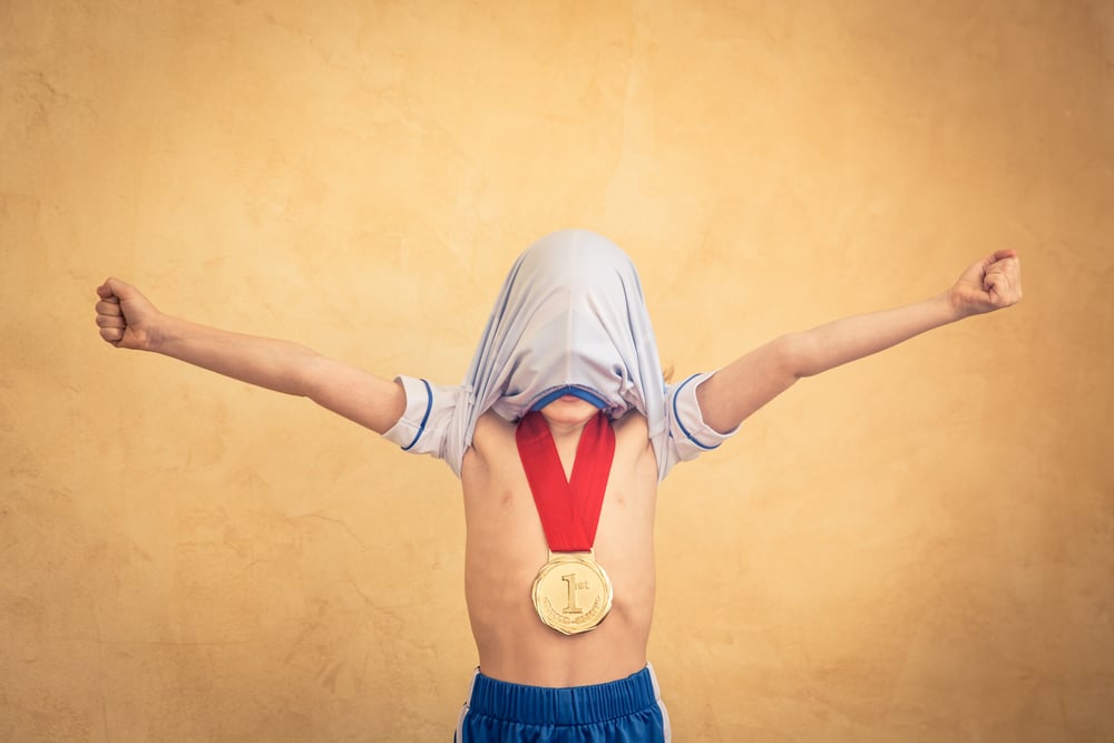 little boy winner with medal