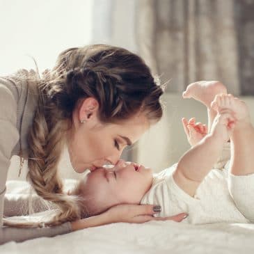 woman kissing baby