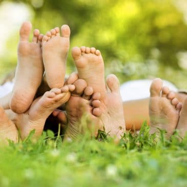 family feet on grass