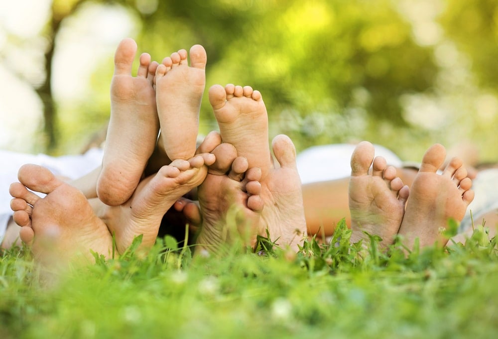 family feet on grass