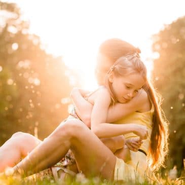 mother and kid embrace sun