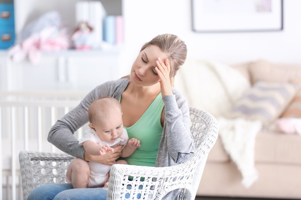 tired woman with baby