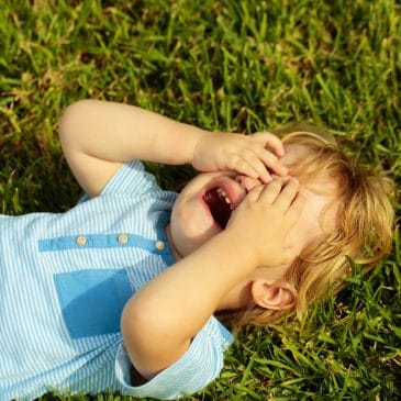 kid crying on grass