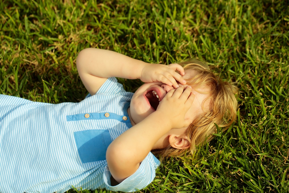 kid crying on grass