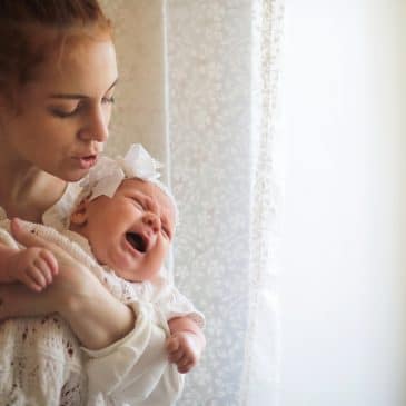 sad woman with newborn