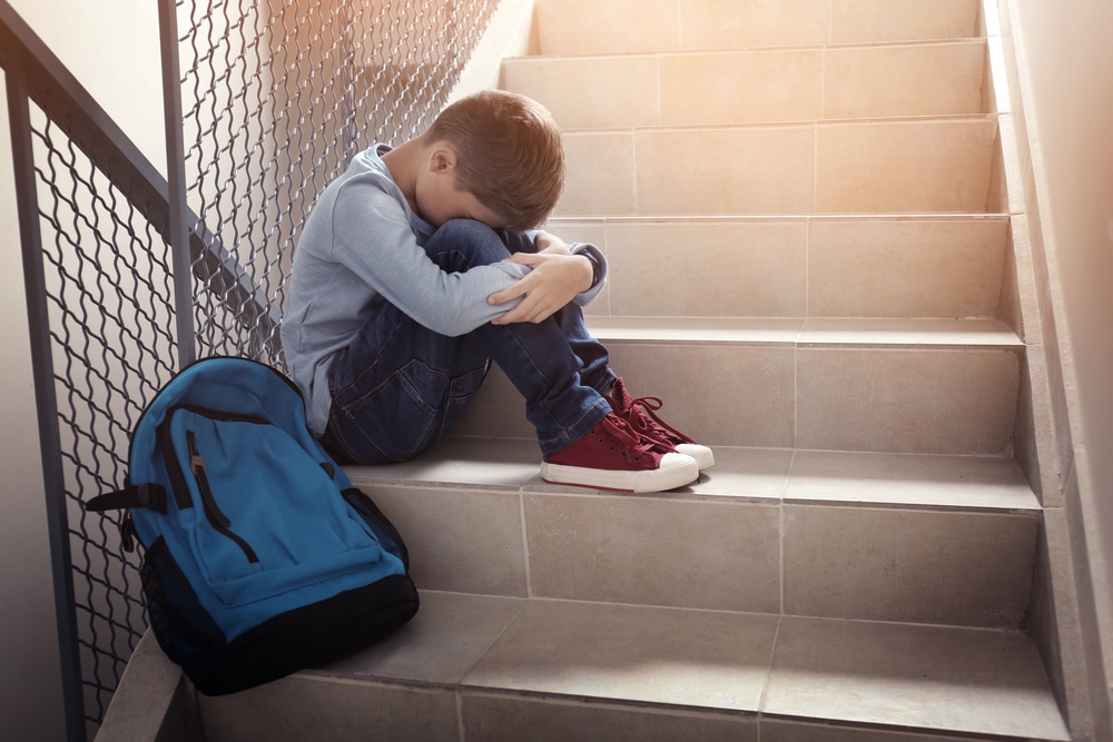 sad little boy at school bully concept
