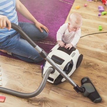 father vacuum with baby