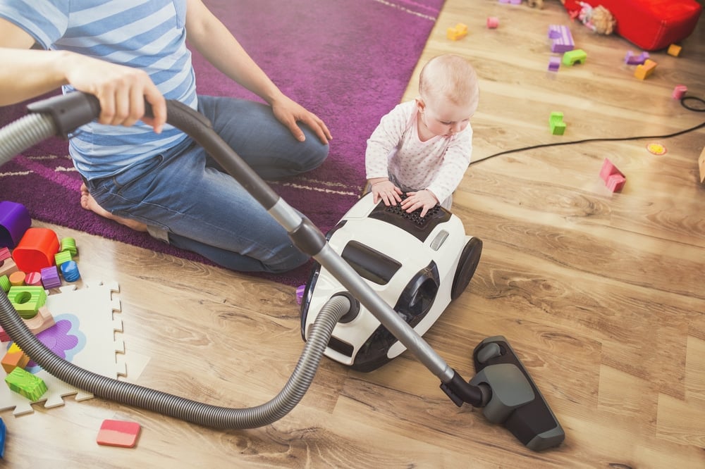 father vacuum with baby