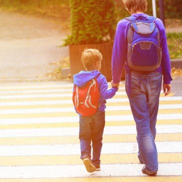 kid going to school with mother