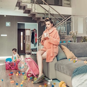 mother with kid in messy living room