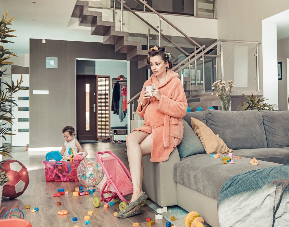 mother with kid in messy living room