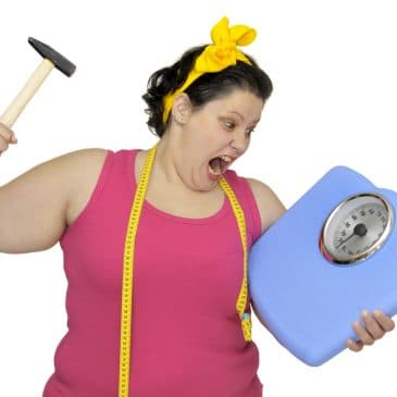 angry woman breaking scale