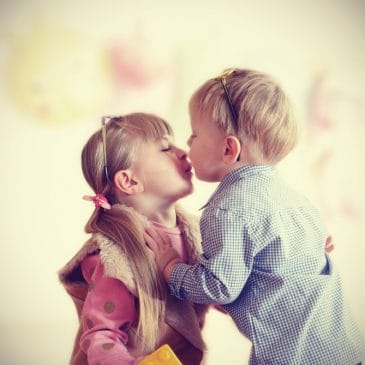 little girl kiss little boy