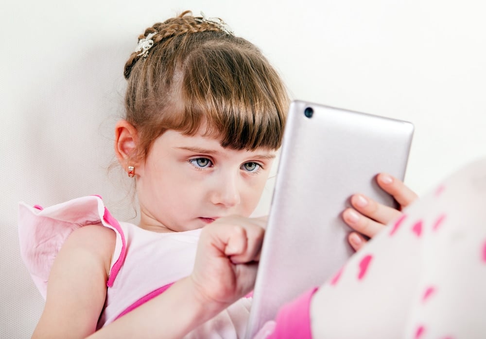 little girl on tablet