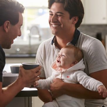 two dads with baby