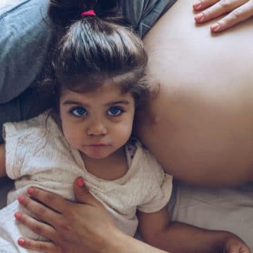 little girl with pregnant mother