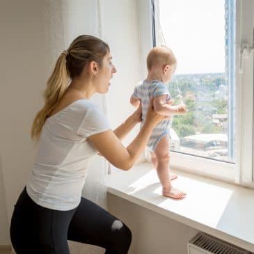 woman with baby near of window