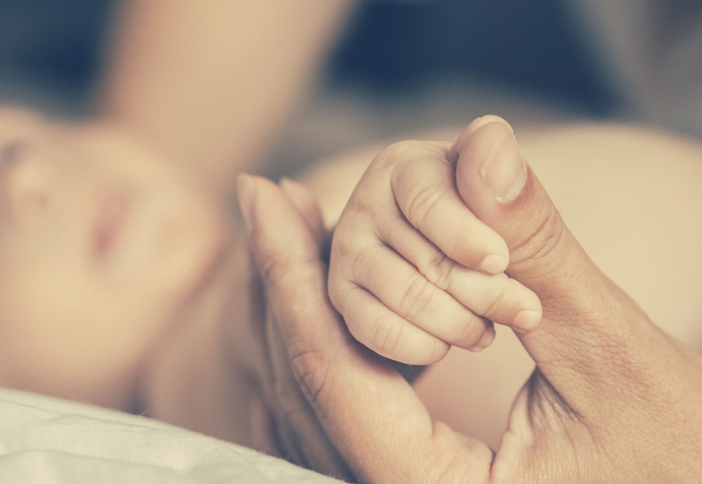 newborn and mother hands