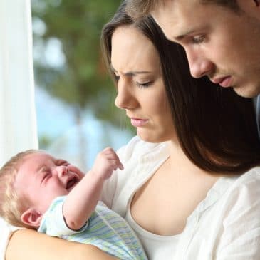 tired couple with baby
