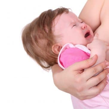 mother breastfeeding baby crying