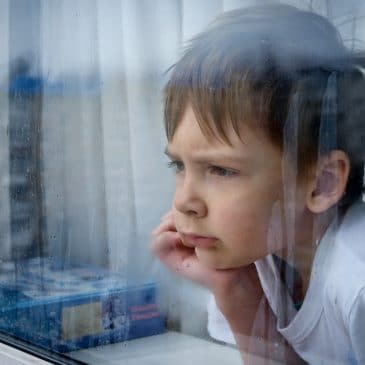 kid waiting in window