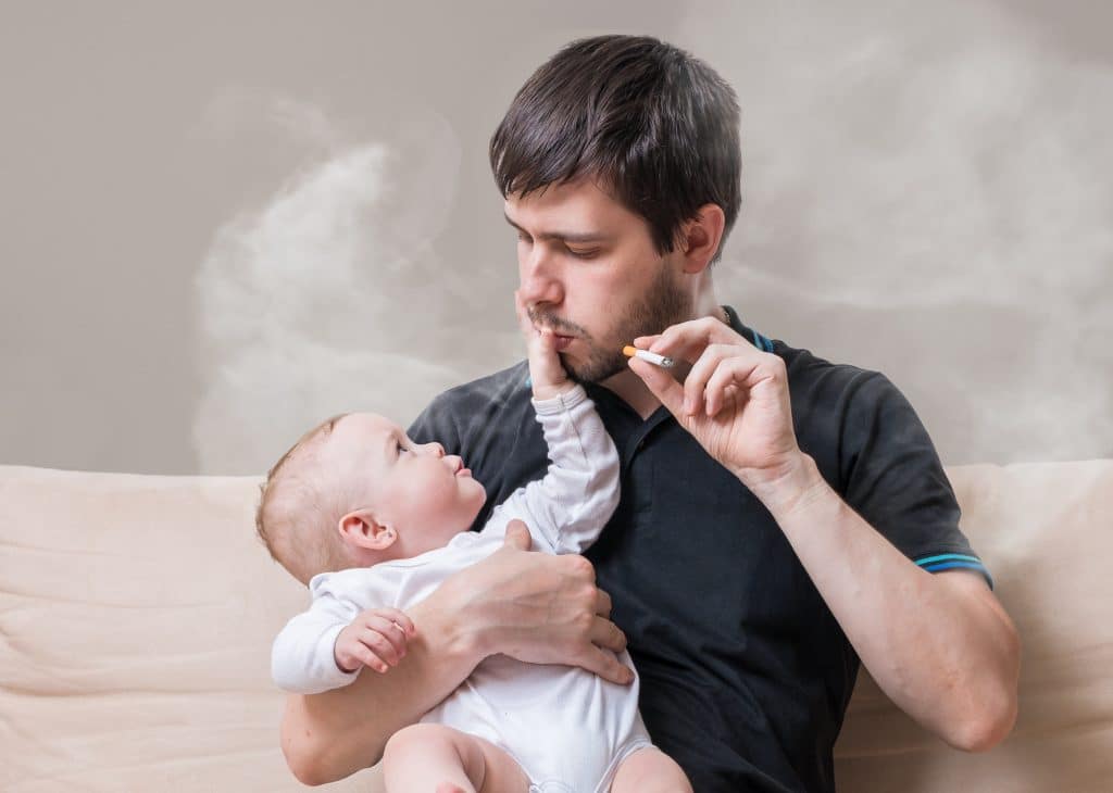 man smoking with baby
