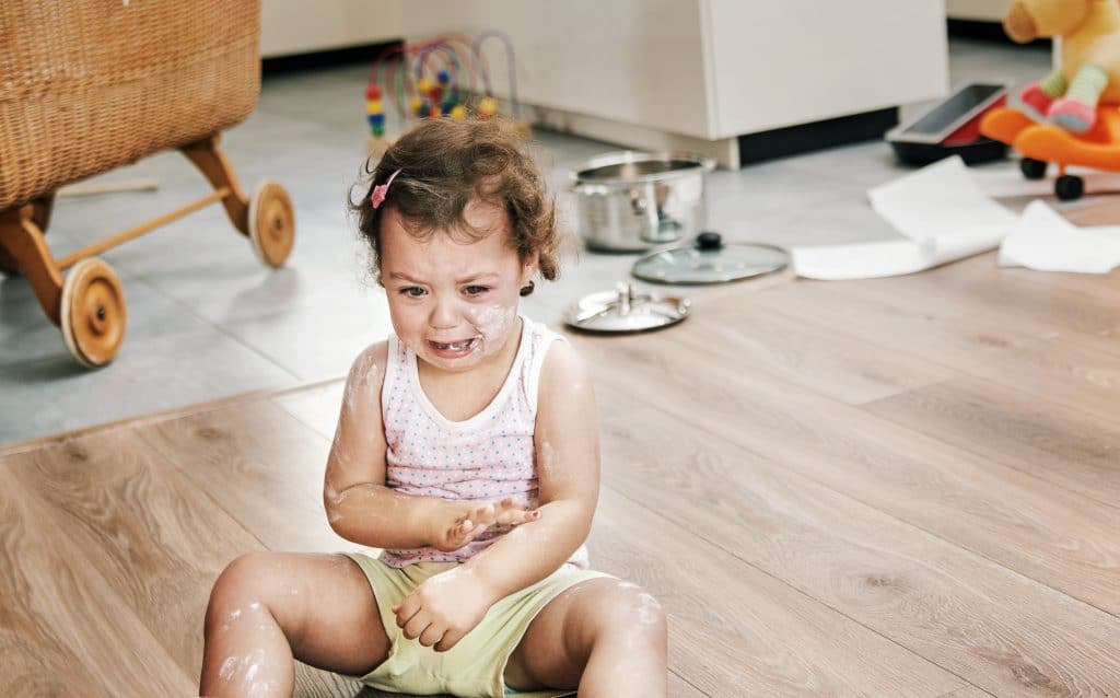 little girl crying on floor