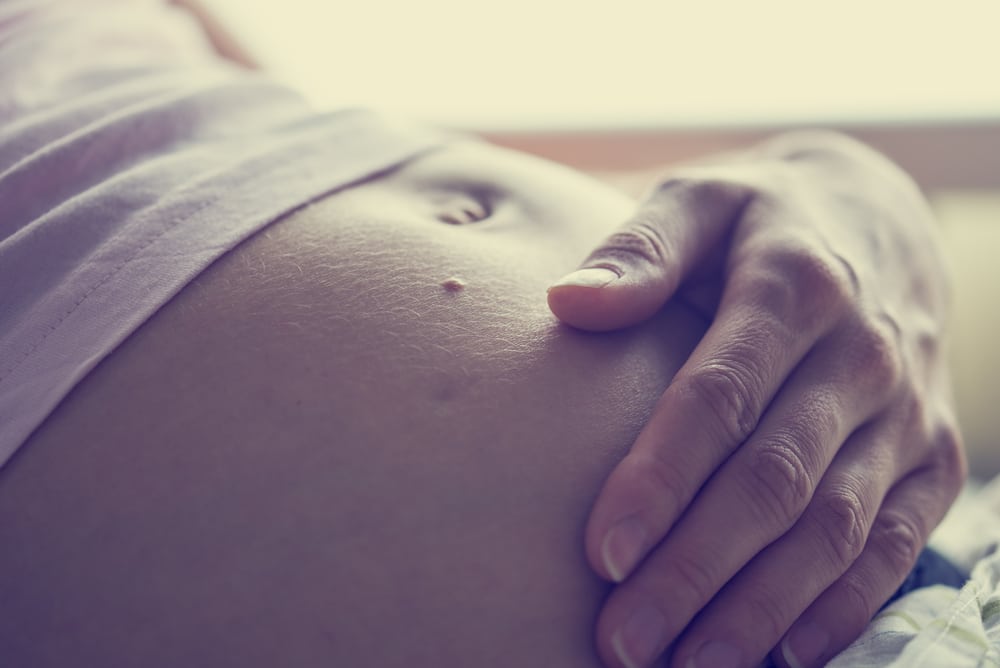 pregnant woman belly and hand