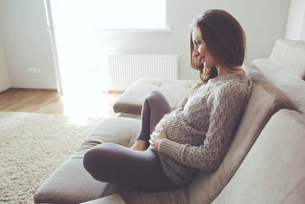 pregnant woman happy on couch