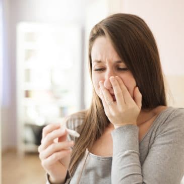 woman with pregnancy test crying