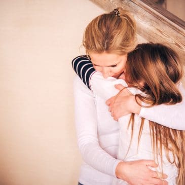 mother embrace crying teenager girl
