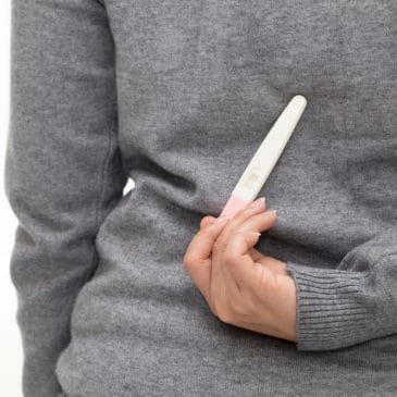 woman hide pregnancy test