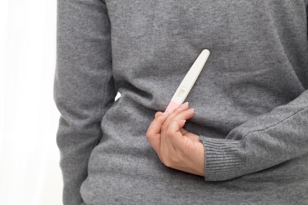 woman hide pregnancy test