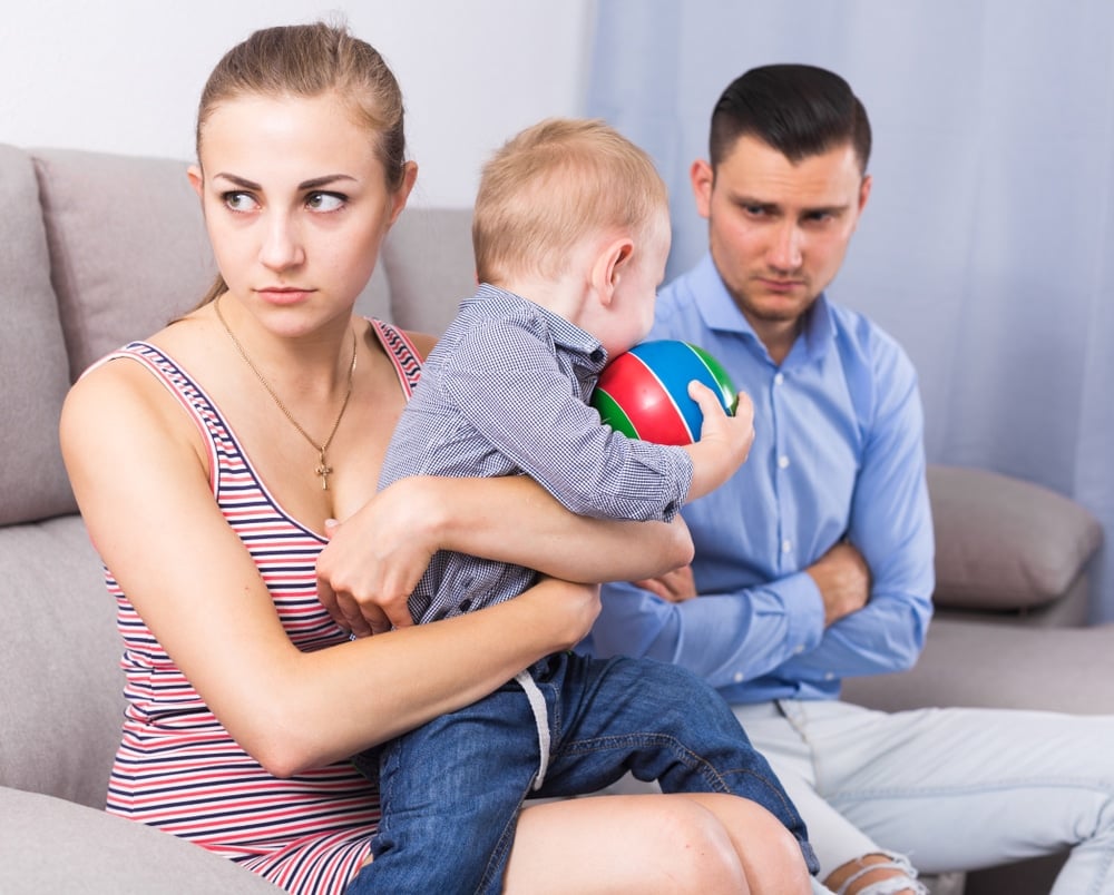 depressed mother with baby and angry father